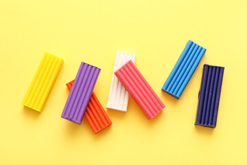 Colorful plasticine on yellow background