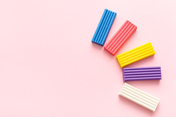 Colorful plasticine on pink background