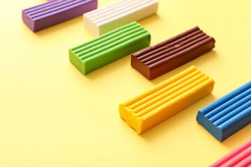 Fototapeta premium Colorful plasticine on yellow background
