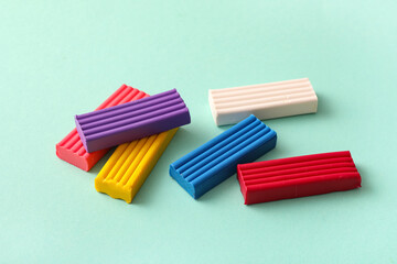 Colorful plasticine on turquoise background