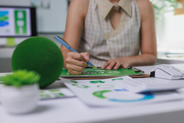 Person writing esg report for sustainable business strategy