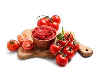 Bowl of tasty tomato paste with basil leaves and vegetables on white background