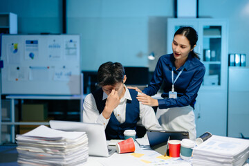 Naklejka premium Asian businesswoman comforting stressed coworker in modern office, showing empathy, teamwork, and emotional support at workplace.