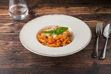 Penne pasta tossed in rich tomato sauce with fresh basil