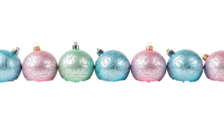 Pastel christmas baubles with silver glitter patterns resting in fluffy snow on a white background with copy space for a modern festive holiday concept