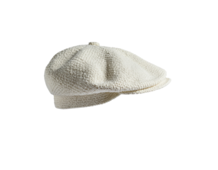 A cozy knitted beret hat made from soft, cream-colored yarn with a textured pattern and a rounded crown design