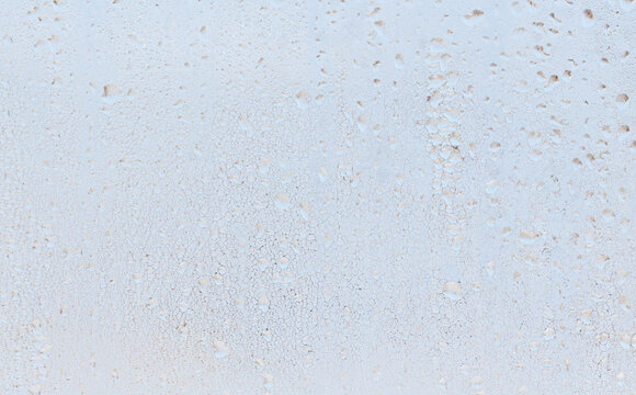 Frozen water drops on glass as an abstract background.