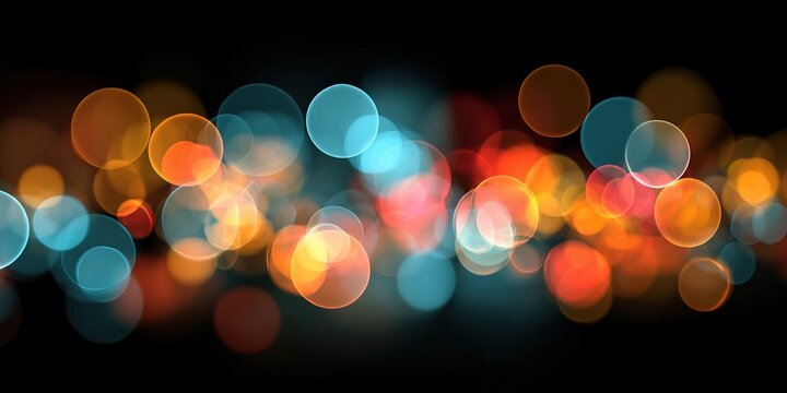 Colorful bokeh lights in abstract blurred form on a dark black background. Glowing light effects create a festive atmosphere for New Year greetings. Stylish design for a party or celebration card