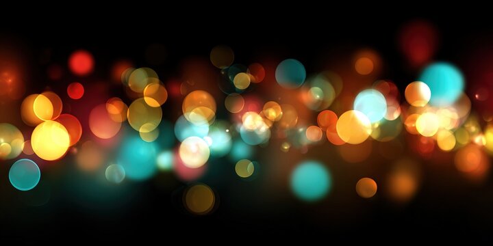 Colorful bokeh lights in abstract blurred form on a dark black background. Glowing light effects create a festive atmosphere for New Year greetings. Stylish design for a party or celebration card