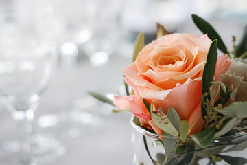 Blossom wedding bouquet of roses on a decoration arranged place setting. 
