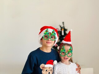 portrait of girl and boy in a christmas hat