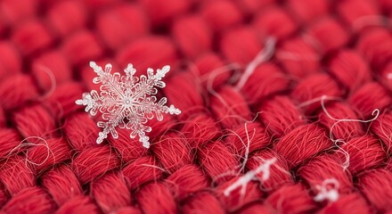 Intricate snowflake rests gently on a textured vibrant red knitted fabric surface