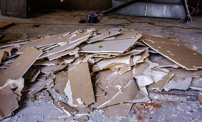Destruction visible in a multi-story building collapse amidst rubble and debris during daylight...