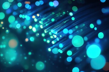 Bright blue and green lights glow on thin strands of material showing a soft blur effect.