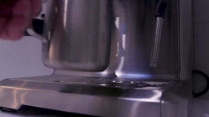 A close-up of a coffee machine in action, showcasing the brewing process of a rich espresso. The sleek design enhances the modern kitchen ambiance, creating a warm, inviting atmosphere.