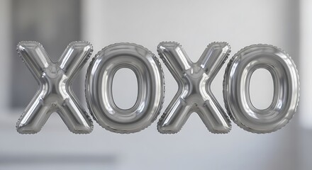 Shiny silver inflatable balloons forming the word xoxo for a celebration