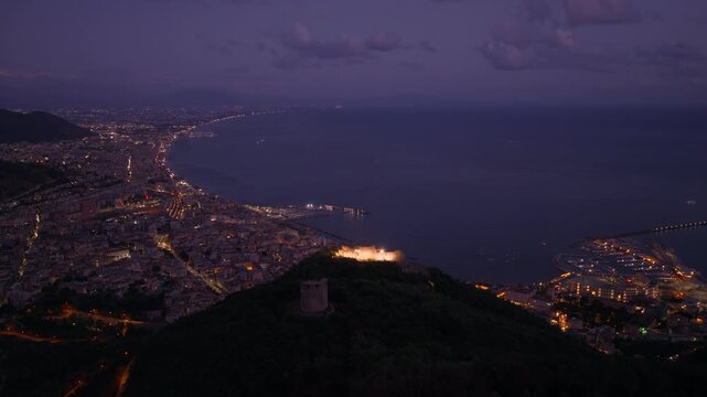 Illuminated Arechi Castle At Night Atop Monte Bonadies In The City Of Salerno, Italy. Aerial Drone Shot
