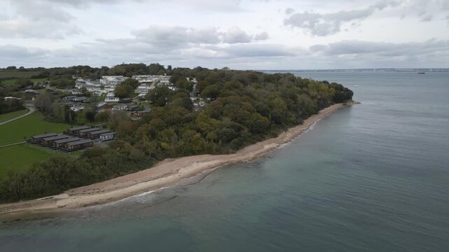 Aerial view of St Helens village named in dedication to St Helena Church, a destroyed church built in the 12th century, Cluniac priory. Only the tower of the church remains, drone moving forward.