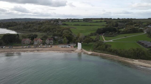 Aerial view of St Helens village named in dedication to St Helena Church, a destroyed church built in the 12th century, Cluniac priory. Only the tower of the church remains, drone moving left.