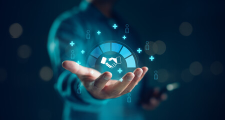 Businessman holding digital handshake icon surrounded by social connection and networking symbols. Concept for partnership, collaboration, CRM, B2B marketing, and business relationship.