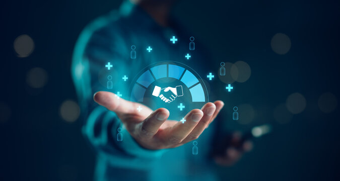 Businessman holding digital handshake icon surrounded by social connection and networking symbols. Concept for partnership, collaboration, CRM, B2B marketing, and business relationship.