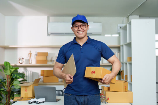 Logistics Worker. A delivery professional smiling while holding packages and clipboard.