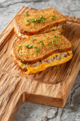 Breakfast Tuna Melt sandwich made of rye bread, canned tuna and melted cheese close-up on a wooden...