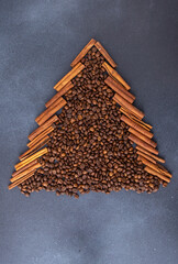 Christmas tree shape aroma food background. Coffee beans and cinnamon sticks top view.