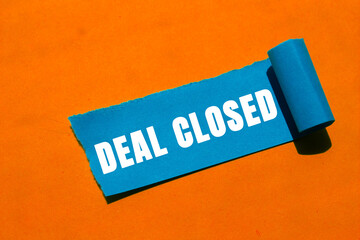 Deal Closed message written on ripped torn paper background. Conceptual Deal Closed symbol. Copy...