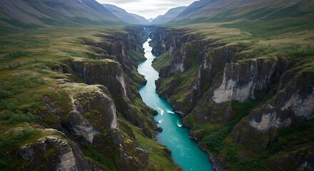 Aerial View of a Turquoise River Winding Through a Green Canyon.