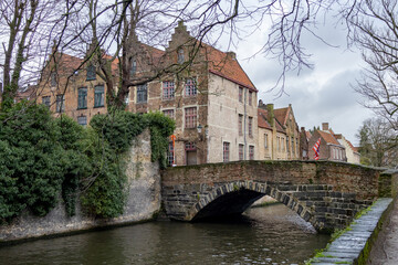 Beautiful city skyline of the village building architecture along a river rozenhoedkaai Rosary Quay canal reflection in Brugge Flanders Belgium
