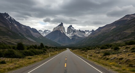 Naklejka premium Road to Majestic Mountains Under Cloudy Sky.