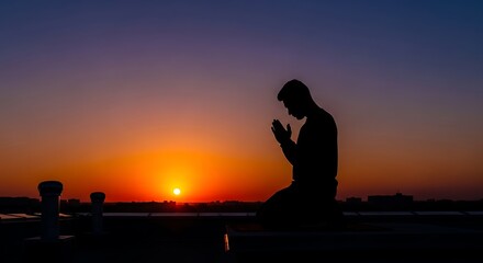 Golden Hour Serenity: Silhouette of a Person Kneeling in Prayer or Contemplation Against a Vivid Sunset Horizon