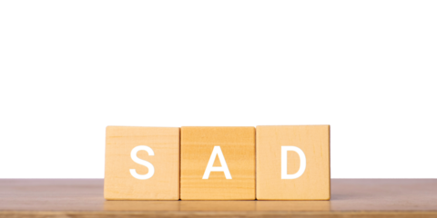 Wooden blocks with word sad for emotion and mood concept, isolated on transparent background