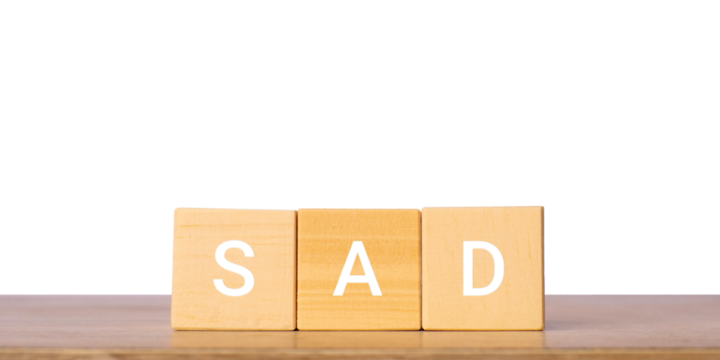 Wooden blocks with word sad for emotion and mood concept, isolated on transparent background