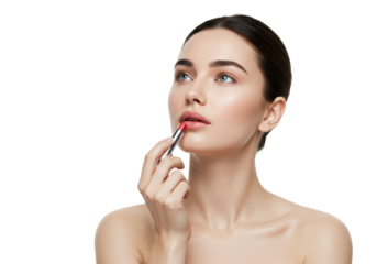 Young caucasian woman (20s) with dark hair, bare shoulders, applying red lip balm to lower lip, thoughtful gaze, high-key beauty light, blurred white studio background, concept of elegant self-care