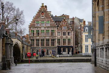 Obraz premium Traditional medieval style buildings along the central downtown region of Ghent Belgium. Photo taken on a cloudy day in Flanders