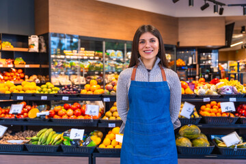 Greengrocer woman smiling working in produce store