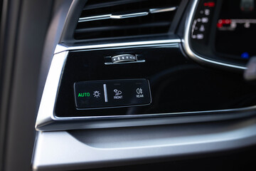 Headlight switch, on off mode lights, automatic control of switching on and off the car light. Mode of lamp electric car. Lights switch cars, car interior. Modern LED matrix laser car headlights.