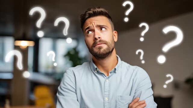 A young man stands with a thoughtful expression as he surrounded by various question marks in a contemporary living room