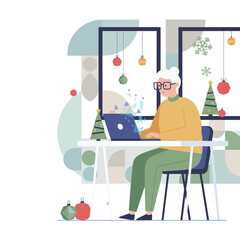 Senior woman uses laptop in a festive home office connecting digitally during the Christmas holidays