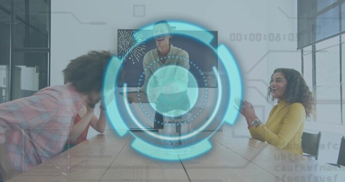 Laughing coworkers in plaid, polka-dot and mustard tops meeting around table in office, with HUD