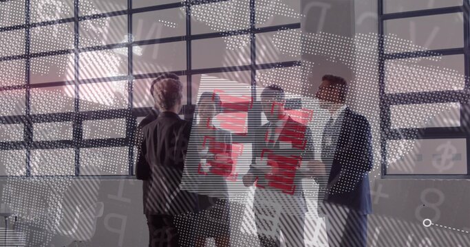 Holding red presentation board, five team members in suits pointing and examining in meeting room