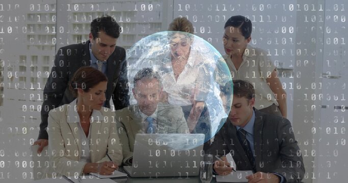 Reviewing executives in suits leaning toward open laptop at meeting room, globe and binary overlays - Powered by Adobe