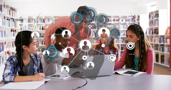 Leading mature instructor wearing red shirt guiding students at library with open laptop, tablets
