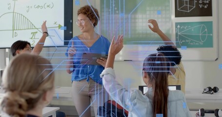 Teaching female teacher with tablet wearing blue blouse explaining math boards in school  and  AR gr
