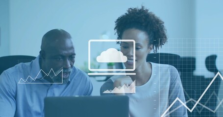 Leaning pair wearing blue shirt and light blouse analyzing laptop at office with cloud charts