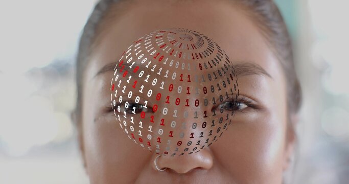 Framing adult Chinese woman facing camera indoors, showing silver hoop nose ring and binary sphere