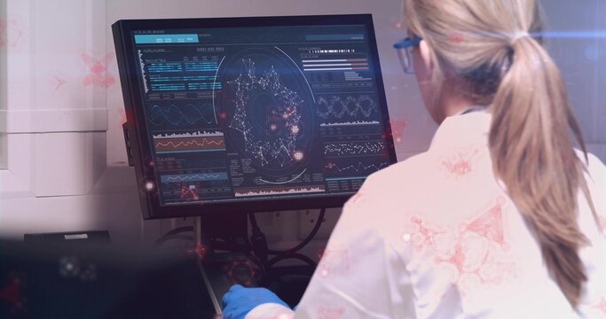Viewing woman wearing labcoat gloves and goggles analyzing data onscreen at lab desk, copy space