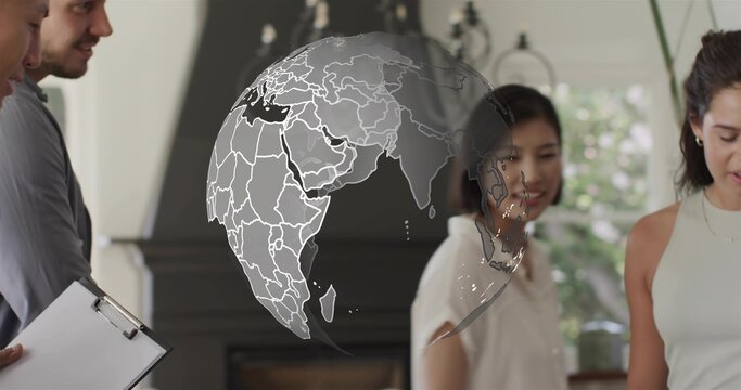 Discussing team in business shirts surrounding digital globe overlay by window, with clipboard - Powered by Adobe